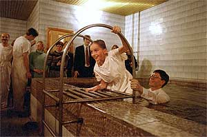 Smiling Mormon teen exiting a baptismal font