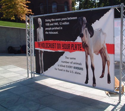 Emaciated camp prisoner on left, emaciated cow on right; "During the seven years between 1938 and 1945, 12 million people perished in the Holocaust. The same number of animals is killed every four hours for food in the U.S. alone. The Holocaust is on Your Plate"