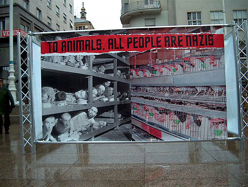 Camp prisoners in bunks on left, chickens in cages on right; "To animals, all people are Nazis"