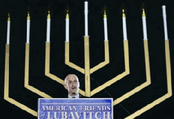 Chertoff, with huge menorah behind him; "American Friends of Lubavitch"